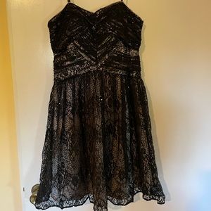 Adrianna papel Strapless dress in net with sequins. Black with nude underskirt.